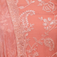 Close-up of elegant coral peach suit with delicate embroidery