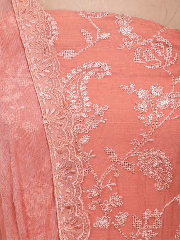 Close-up of elegant coral peach suit with delicate embroidery
