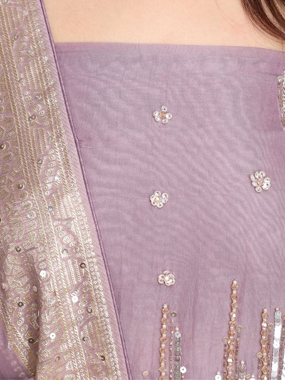 Close-up of shimmer-detailed suit in a dreamy mauve hue for evening glam