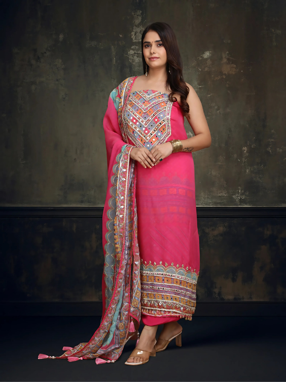 Vibrant pink ethnic ensemble with intricate mirror work and scalloped printed dupatta 