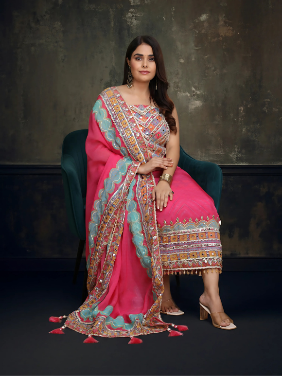 Vibrant pink ethnic ensemble with intricate mirror work and scalloped printed dupatta 