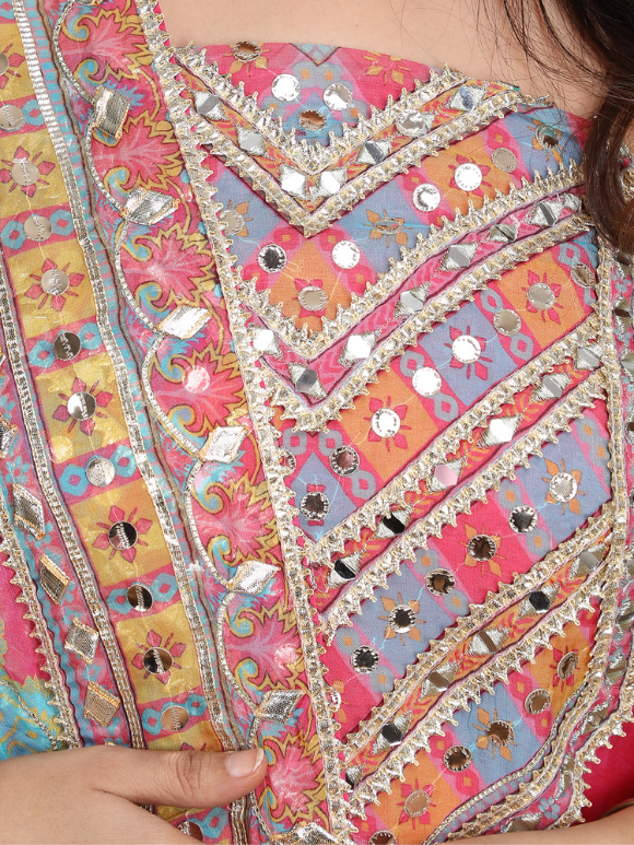 Close-up of vibrant pink ethnic ensemble with intricate mirror work and scalloped printed dupatta 