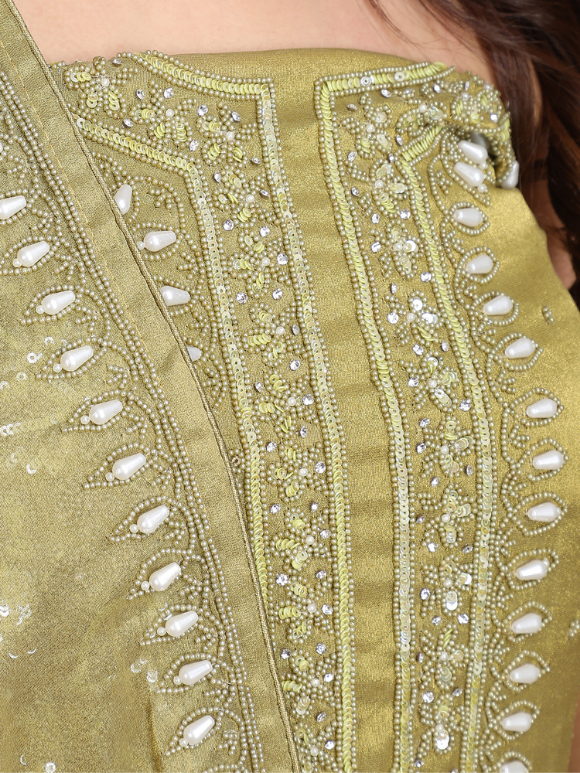 Close-up of embellished suit in mustard tones is a perfect mix of elegance and festive charm