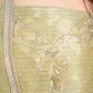 Close-up of pastel gold ensemble is crafted to reflect subtle shine and graceful charm. 