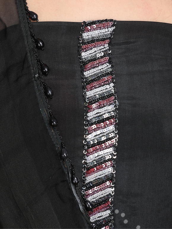 Close-up of Classic black ensemble with subtle embellishments and a flowy dupatta